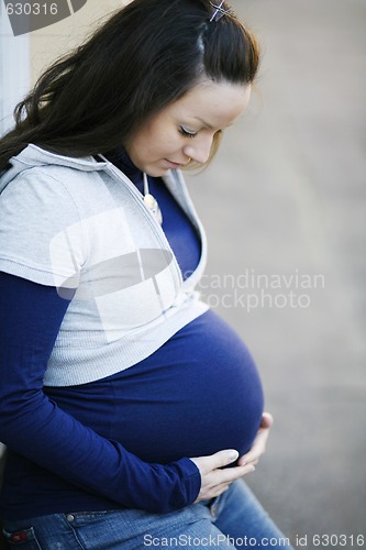 Image of Young pregnant woman outdoors.
