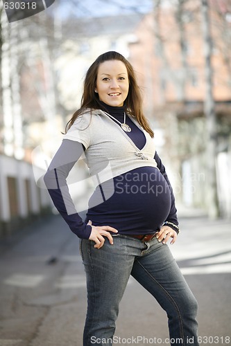 Image of Happy young pregnant woman outdoors.