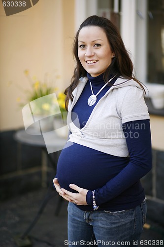 Image of Happy young pregnant woman outdoors.