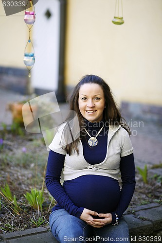 Image of Happy young pregnant woman outdoors.