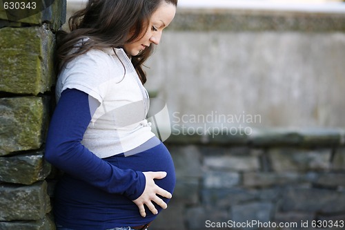 Image of Young pregnant woman outdoors.