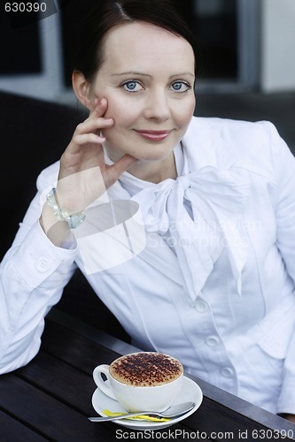 Image of Portrait of a beautiful business woman with a cappuccino.