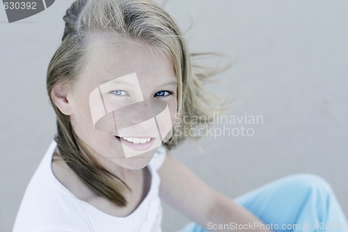 Image of Close-up portrait of a pretty, blonde haired teenage girl outdoo