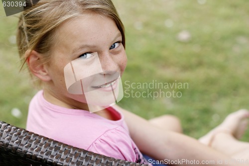 Image of Close-up portrait of a pretty, blonde haired teenage girl outdoo