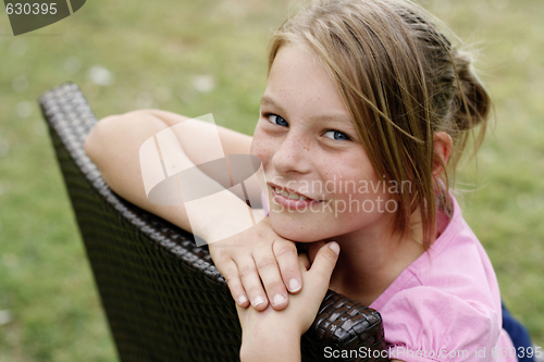 Image of Close-up portrait of a pretty, blonde haired teenage girl outdoo