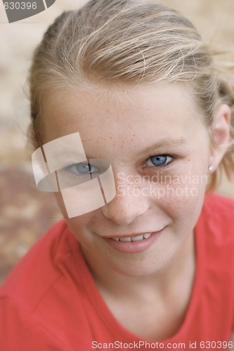 Image of Close-up portrait of a pretty, blonde haired teenage girl outdoo