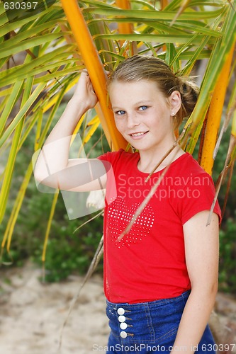 Image of Pretty, blonde haired teenage girl outdoors at the beach.