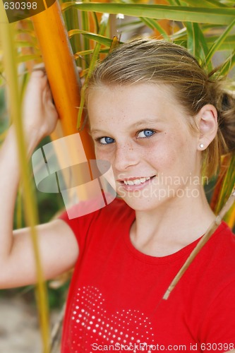 Image of Pretty, blonde haired teenage girl outdoors.