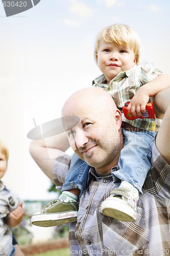 Image of Happy father and two sons outdoors.