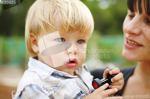 Image of Happy mother and son outdoors.