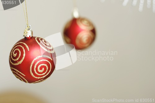 Image of Two red decorative Christmas baubles.