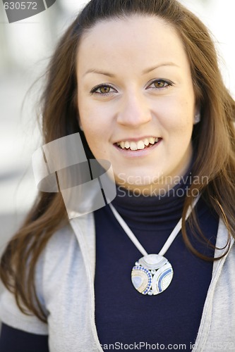 Image of Portrait of a young happy and contented woman outdoors.