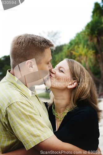 Image of Portrait of a happy married couple kissing.