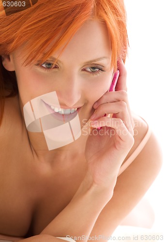 Image of happy redhead woman with cell phone