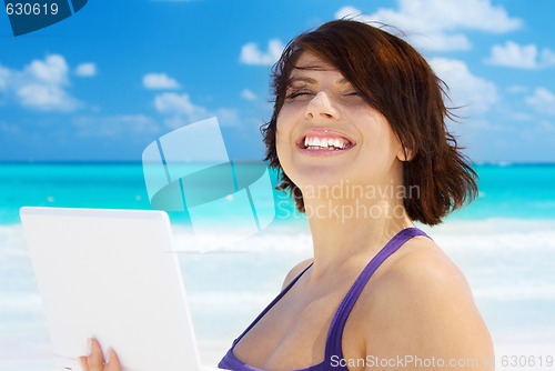 Image of woman with laptop computer on the beach
