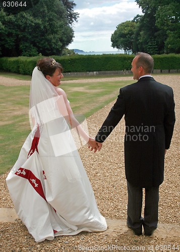 Image of Back of Bride and Groom Holding Hands