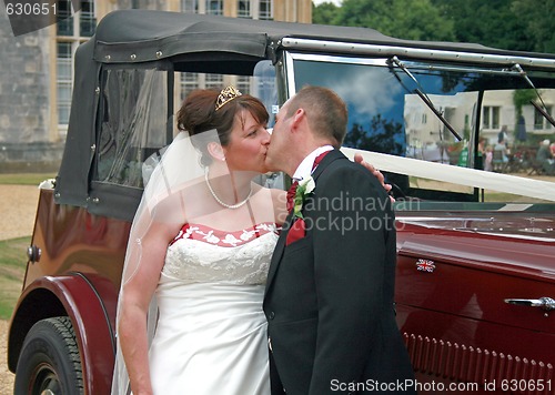 Image of Kissing in front of Wedding Car