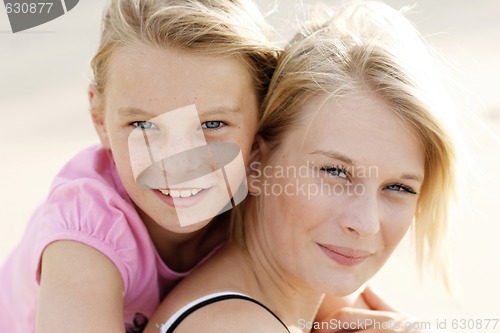 Image of Two happy young sisters together outdoors.