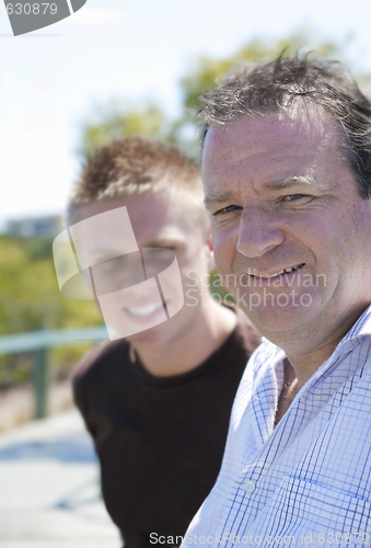 Image of Happy father and son together outdoors.