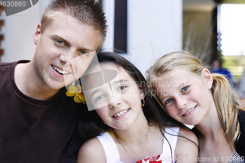 Image of Portrait of three happy adolescents together outdoors.