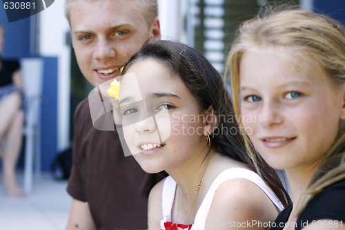 Image of Portrait of three happy adolescents together outdoors.