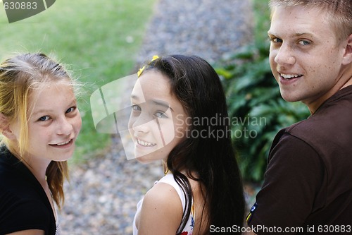 Image of Portrait of three happy adolescents together outdoors