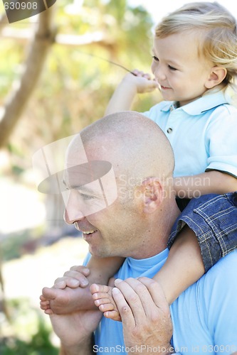 Image of Close-up portrait of a father and son outdoors.