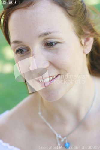 Image of Close-up portrait of a happy attractive woman outdoors.