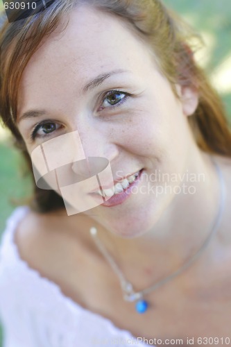 Image of Close-up portrait of a happy attractive woman outdoors.