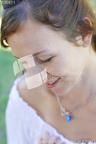 Image of Close-up portrait of a happy attractive woman outdoors.