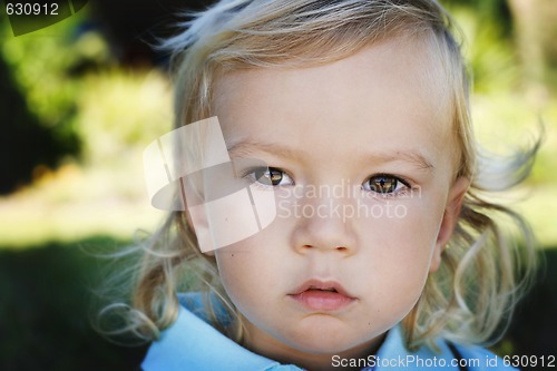 Image of Close-up portrait of a serious looking little boy.
