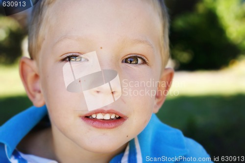 Image of Close-up portrait of a happy young boy.