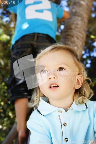 Image of Portrait of a thoughtful looking little boy outdoors.