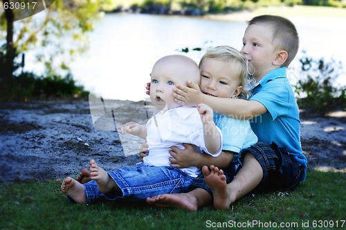 Image of Three happy brothers together outdoors.