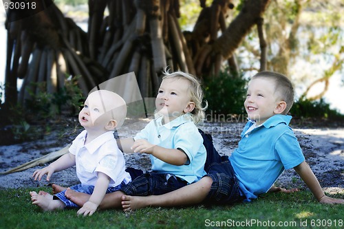 Image of Three happy brothers together outdoors.