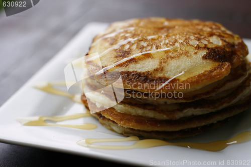 Image of Stack of pancakes with honey.