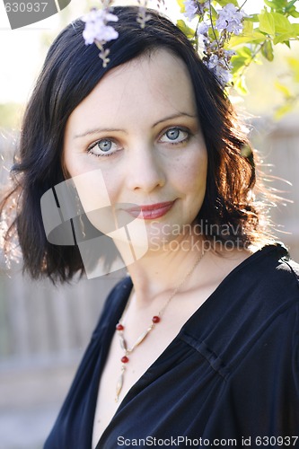 Image of Portrait of a beautiful woman with blue eyes wearing a black out
