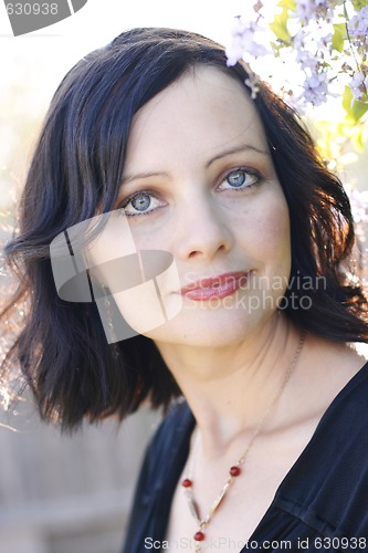 Image of Portrait of a beautiful woman with blue eyes wearing a black out