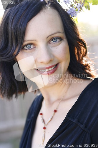 Image of Portrait of a beautiful woman with blue eyes wearing a black out