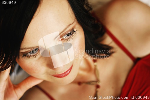 Image of Portrait of a beautiful woman in a red outfit.