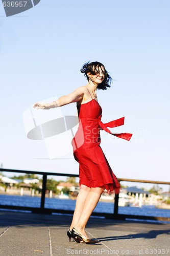 Image of Beautiful woman in a red dress outdoors.