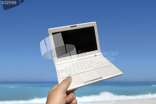 Image of White small Laptop on the beach