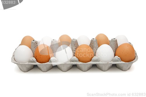 Image of White and brown eggs in a paper box isolated