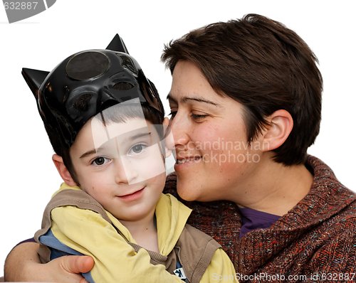 Image of Mother embraces five year son who wears a mask on his head isolated