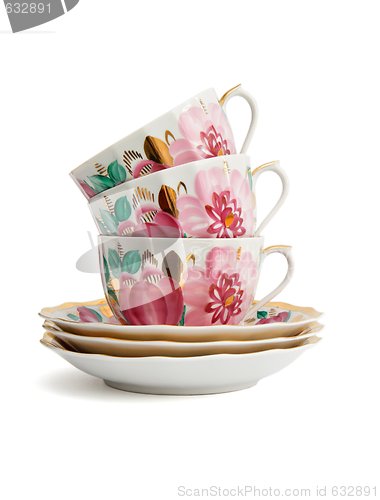 Image of Stack of three porcelain tea cups with saucers isolated 