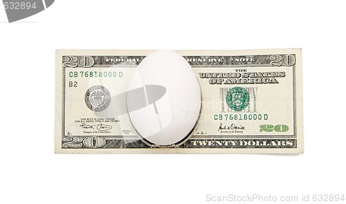 Image of White egg on twenty dollar bill isolated