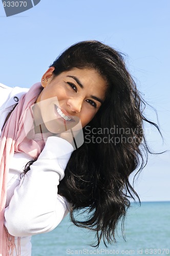 Image of Beautiful young woman at beach