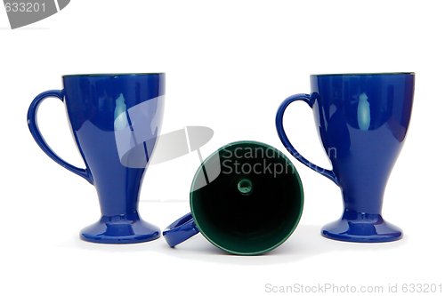 Image of Two standing and one lying blue high coffee cups isolated