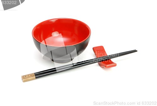 Image of Chopsticks on stand and red and black Japanese bowl isolated