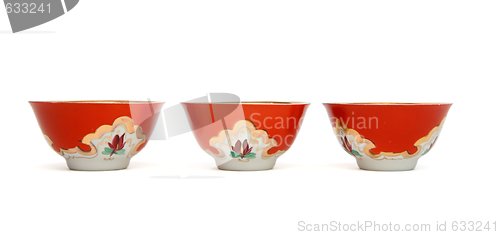Image of Three small red porcelain bowls isolated
